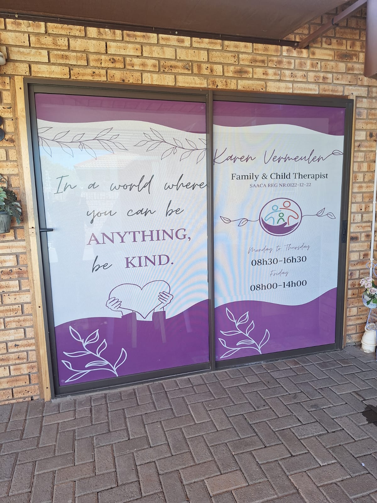 The front windows of Karen's practice with her logo and opening hours
